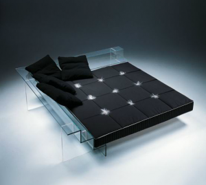 black bedding on a glass bed