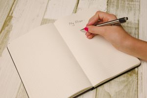 women taking notes inside a notebook