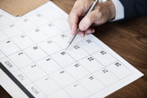 man marking on a calendar