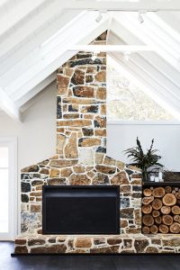 multi tone browns stone fireplace with wood storage 