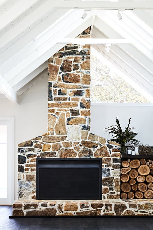 multi tone browns stone fireplace with wood storage