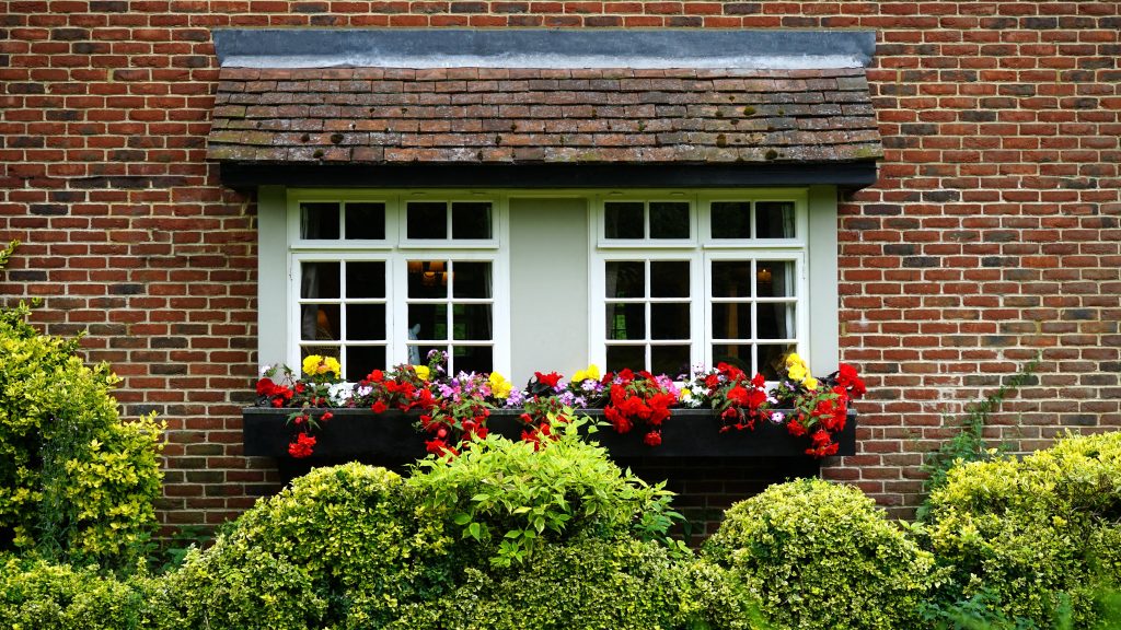 outside view on home on windows with flower bed landscaped