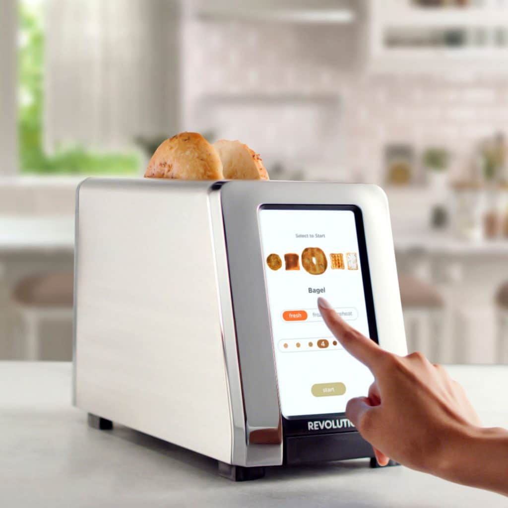 touchscreen smart toaster in a kitchen with a bagel in it