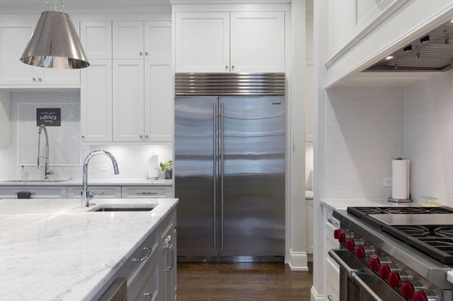 kitchen with stainless steel appliances - refrigerator, dishwasher, and stove 