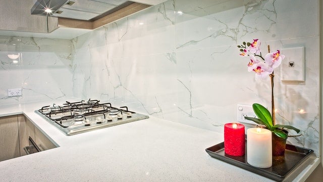 modern kitchen marble backsplash white and grey over stainless steel stovetop