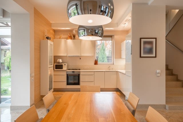 kitchen remodel renovation modern simple kitchen with light wood details and stainless steel lighting