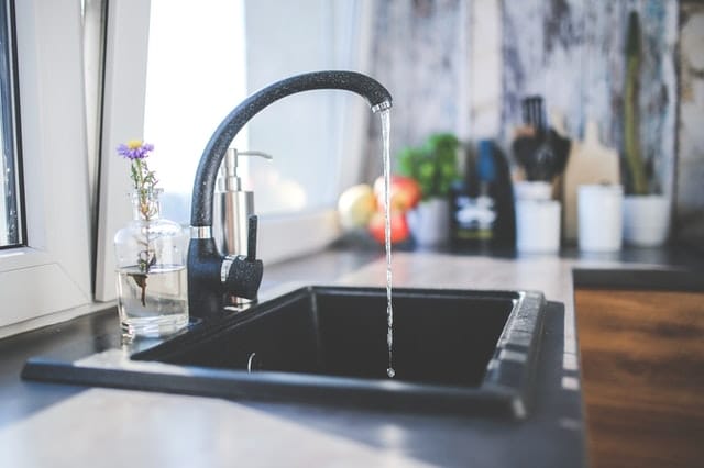 black basin kitchen sink with running water