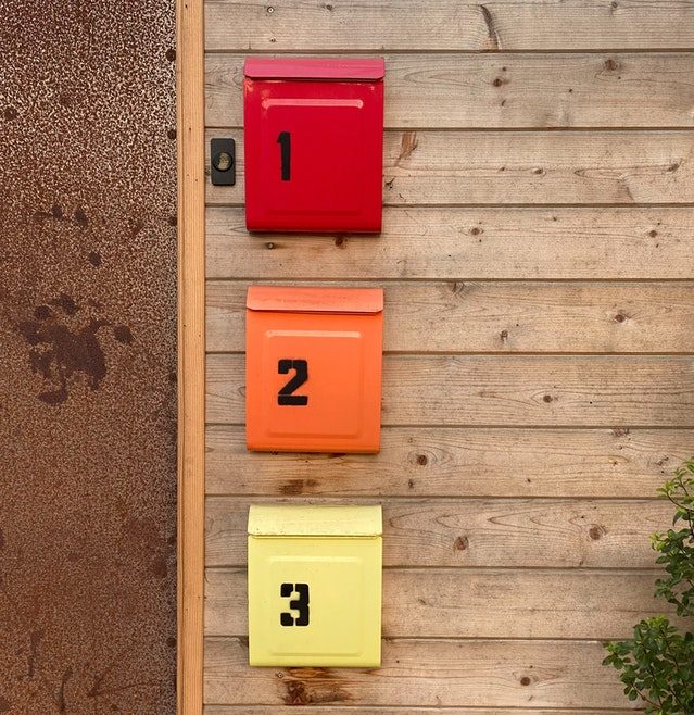 numbers on colorful mailboxes outside house