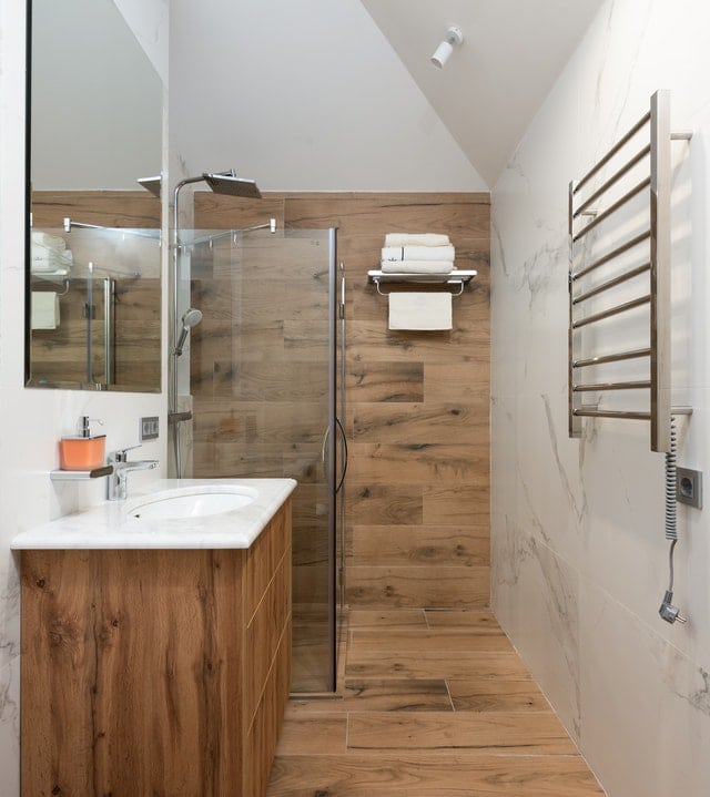 Modern bathroom with white clean sink and timber walls