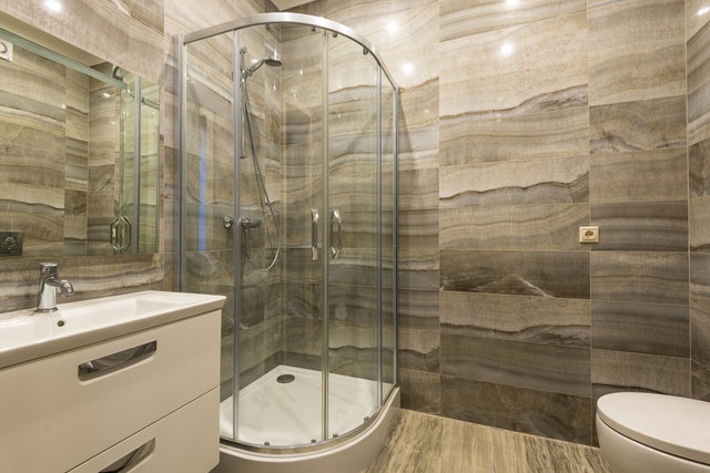corner shower with glass surrounding